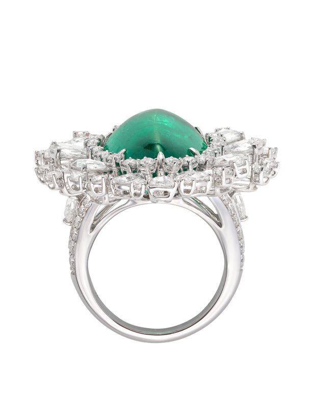 Cabochon emerald surrounded by round brilliant cut and rose cut diamonds, crafted in 18 karat white gold.