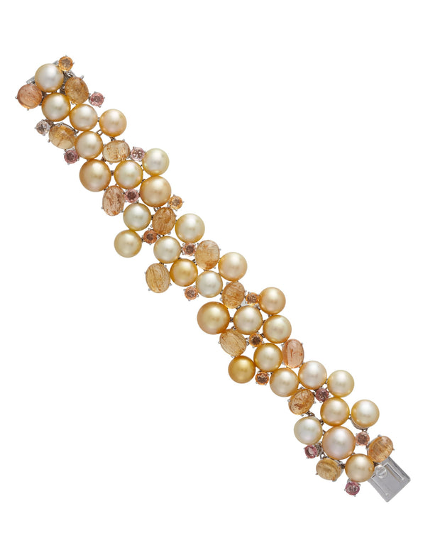 Golden pearl bracelet enhanced with cabochon yellow topaz and yellow sapphire, crafted in 18 karat yellow gold.