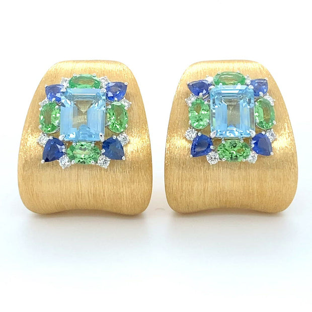 Satin finished earrings, featuring a pair aquamarine, surrounded by diamond, sapphire and tsavorite with double clip and moevable post, crafted in 18 karat white and yellow gold.